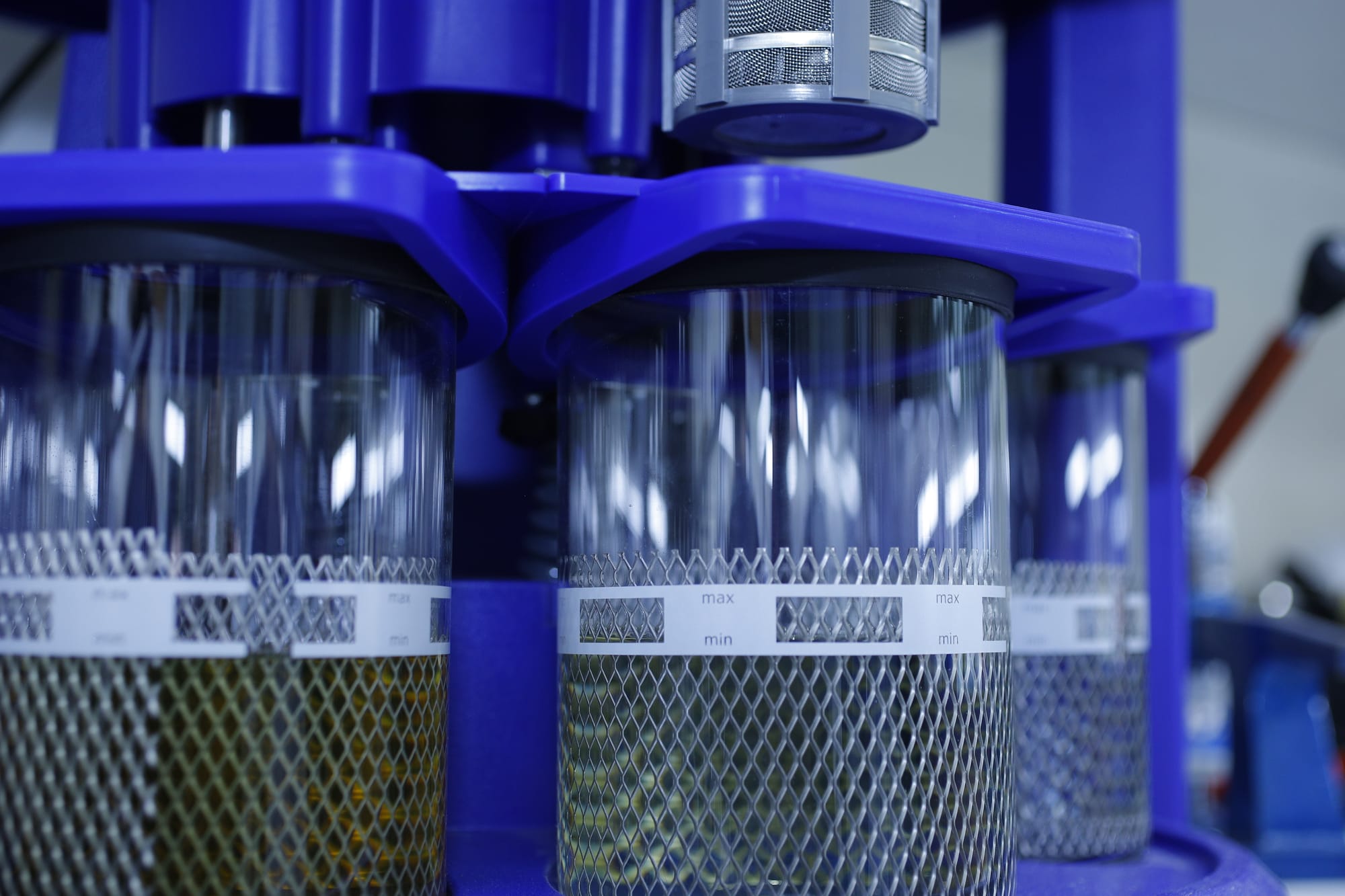 A close-up image of multiple liquid solvent chambers used for watch-part cleaning within an Elma Solvex RM